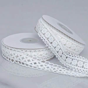 Milk white hollow lace trim with crochet embroidery patterns on white paper rolls