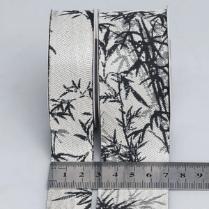 Detailed view of 25mm and 38mm ink wash bamboo pattern ribbons with a measuring ruler