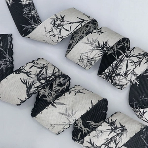 Macro view of Chinese ink wash bamboo leaf pattern ribbon with serrated lace edges