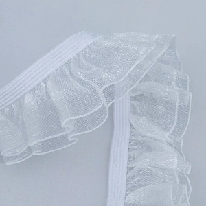 Macro detail of 2.5cm double-layer white pleated organza lace trim with elastic band