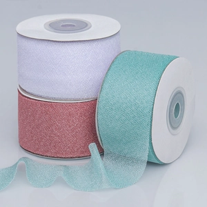 Close-up of semi-transparent sheer organza ribbons in lilac, pink, and seafoam green