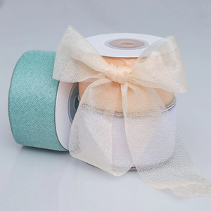 Close-up of semi-transparent mesh ribbons in mint, orange, and beige with decorative bows