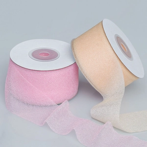 Detail of 4cm sheer mesh ribbon rolls in pink and gold with shimmering glitter finish