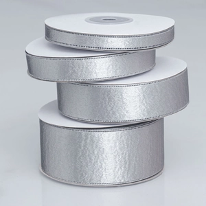 Detailed view of four different widths of silver glitter ribbons for DIY craft sewing