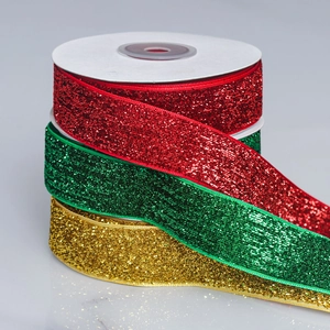 Close-up of glitter ribbon rolls in festive red, green and gold for gift wrapping