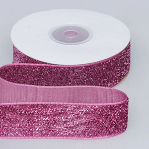 Sparkling rose red metallic glitter velvet ribbon on a white spool for DIY gift wrapping