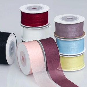 Macro detail of multi-colored organza ribbons 2.5cm rolls for DIY wedding decor