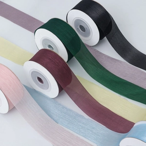Macro detail of multi-colored semi-transparent organza ribbon rolls for wedding decor