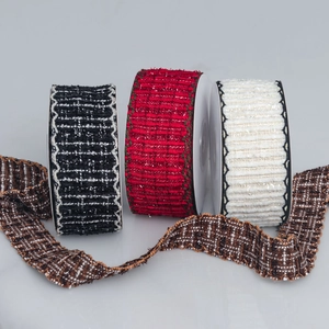 Close-up of textured plaid tweed ribbons with wavy scalloped edges in various colors