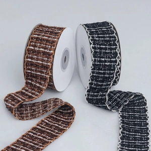 Macro detail of textured tweed ribbons with wavy gold and silver edges for DIY crafts
