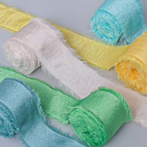 Macro shot of colorful handmade frayed edge satin ribbons for wedding gift wrapping