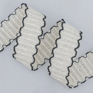 Elegant ivory tweed ribbon with black wavy edges and metallic silver thread for DIY crafts