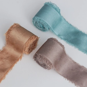 Three rolls of frayed edge silk chiffon ribbons in Morandi tones for wedding gift wrapping