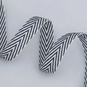 Close-up of navy blue and white herringbone cotton ribbon roll for DIY craft and sewing