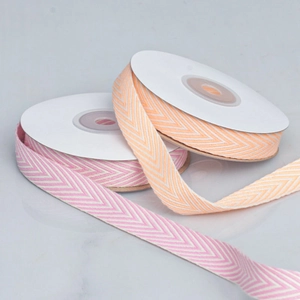 Detailed herringbone pattern cotton ribbon in pink and orange for DIY craft projects