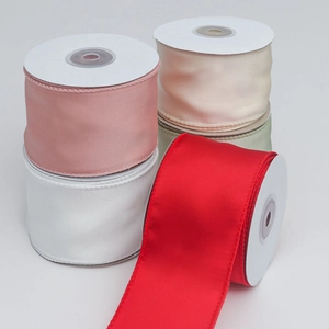 Close-up of five colorful satin ribbons with wired edges for DIY gift wrapping and bows