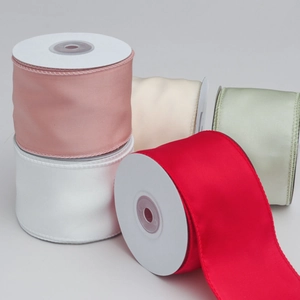 Detail of 6cm wired edge satin ribbon rolls in red, white and pastel shades for DIY crafts