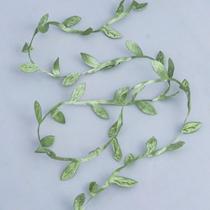Close-up of artificial green leaf vine ribbon with realistic vein texture for DIY crafts