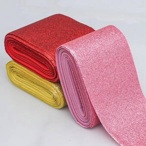 Close-up of red, pink and gold glitter PU leather ribbons for decorative packaging