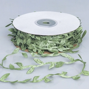 Detailed view of artificial green leaf vine ribbon roll for DIY wreath making