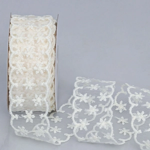 Detail of off-white sheer lace ribbon with snowflake patterns for DIY gift wrapping