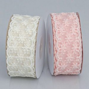 Rolls of cream and pink floral lace ribbon for DIY crafts and gift wrapping decoration