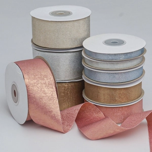 Macro detail of metallic satin polyester ribbons in Morandi tones for gift wrapping