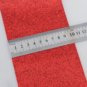 Red glitter PU leather ribbon with non-shedding finish measured on a steel ruler