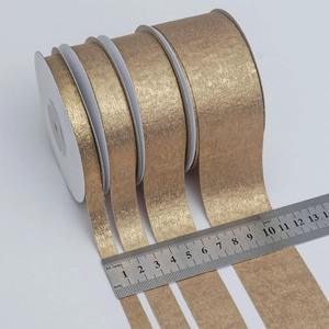Set of four widths of gold satin ribbons with metallic texture for gift packaging and DIY
