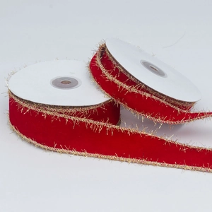 Close-up of red velvet ribbons with golden metallic fringe edges for festive gift wrapping