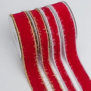 Detail of red velvet ribbons with gold glitter edges and white faux fur trim on rolls