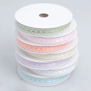 Detail of colorful lace ribbons with heart cutouts and white edges for DIY crafts