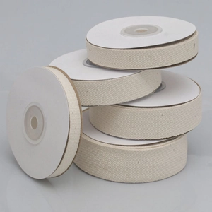 Detail of five rolls of off-white cotton herringbone ribbons in various widths
