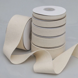 Detailed macro view of 6 rolls of beige cotton twill tape ribbons for DIY crafts and sewing