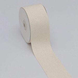 Detail of off-white pearl grain cotton polyester ribbon with diagonal weave texture