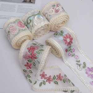 Macro shot of 9cm milk silk floral embroidery lace ribbon for DIY sewing and crafts