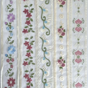 Detail view of 9cm assorted embroidered floral lace trim on white mesh for DIY crafts