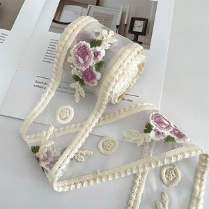 Macro detail of 9cm milk silk mesh lace with rose embroidery for DIY decoration