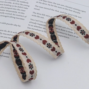 15mm jacquard ribbon with red hearts and black floral patterns and wavy lace edges