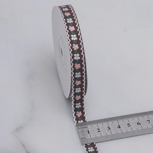 12mm floral jacquard ribbon with embroidery and scalloped lace edge on marble surface