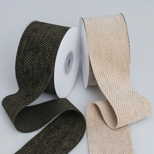 Macro shot of olive green and beige twill velvet ribbon rolls for DIY hair accessories