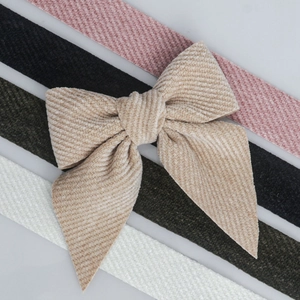 Detailed texture of velvet twill ribbon bows in beige, pink, black and green colors