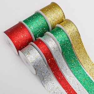 Detail of glitter ribbons with star sequins in red green gold and silver colors