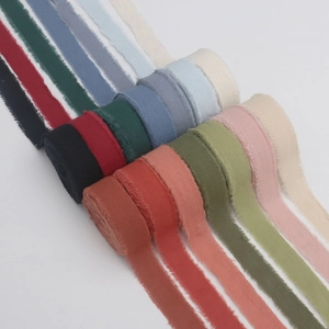 Macro shot of 2.5cm frayed edge cotton linen ribbons in various Morandi colors