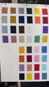 Close-up of a ribbon color chart showing numbered satin fabric swatches for DIY crafts