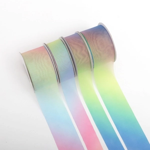 Dettaglio di quattro rotoli di nastri in chiffon sfumato per decorazioni floreali