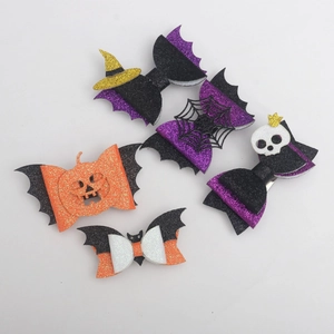 Close-up of 5-piece glitter Halloween hair bows with pumpkin, bat, and spider web details