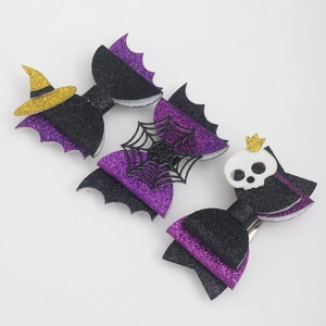 Detail of three Halloween glitter hair bows featuring witch hat, spider web, and skull