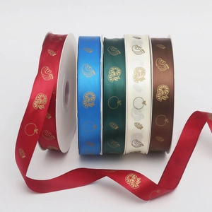 Close-up of five colorful 2.5cm ribbons with elegant gold fruit patterns and glossy finish