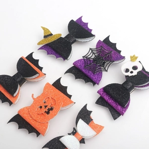 Glittering Halloween bow hair clips with bat wings, spider webs, and pumpkin designs